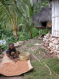Woman Drying Rice